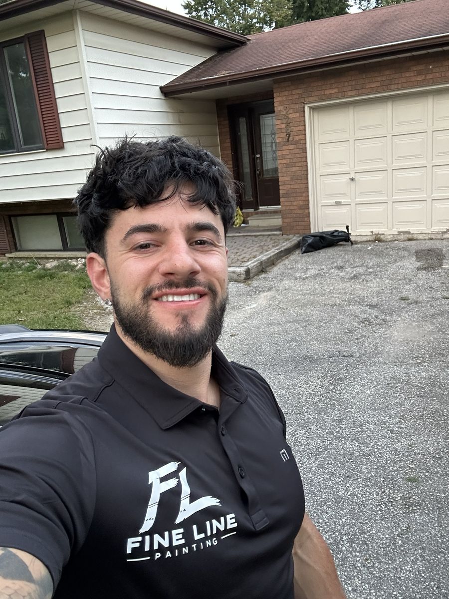 Joey Zanger, owner of Fine Line Painting, outside a client's home