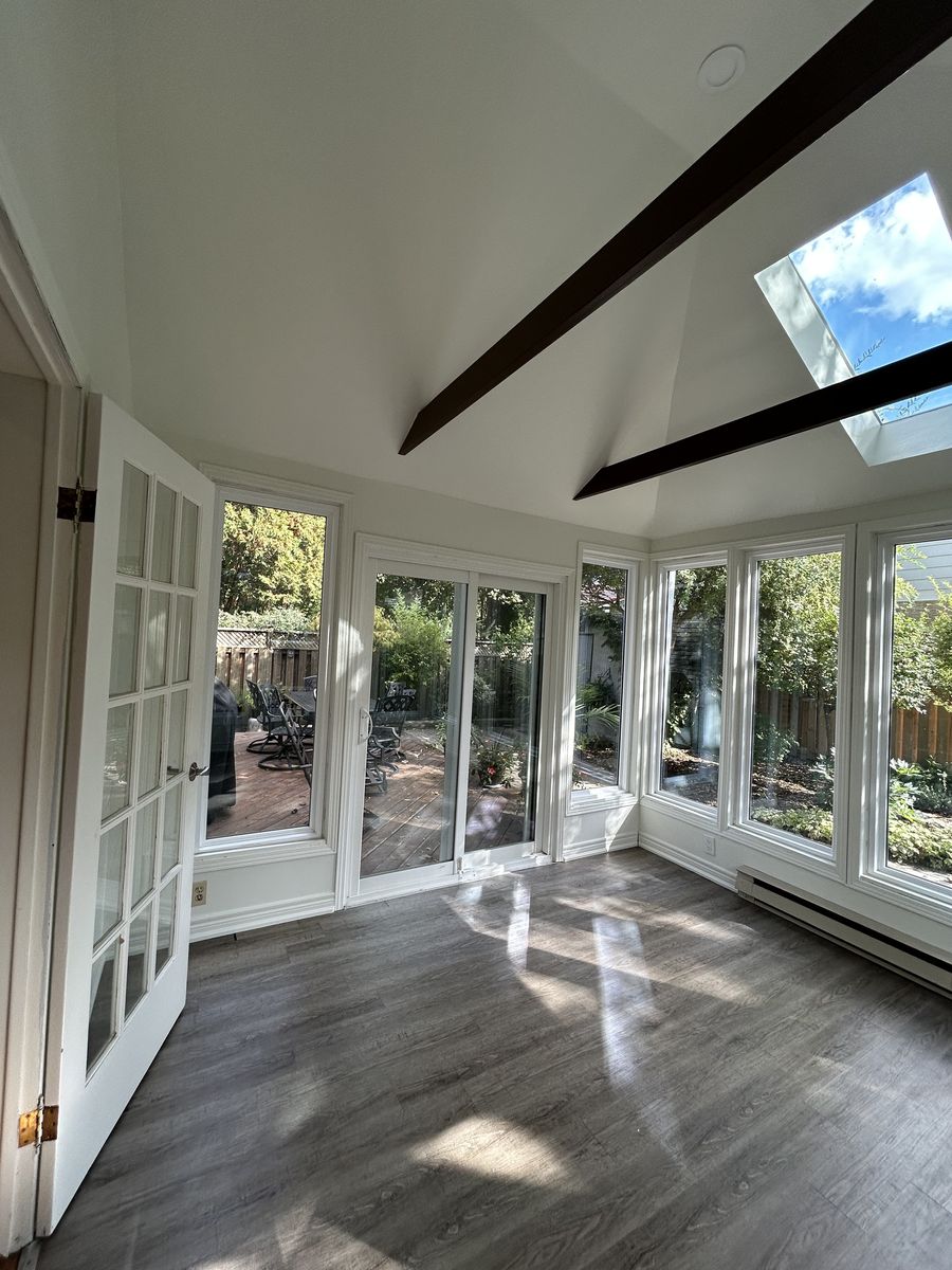 Sunroom after: white walls and ceiling with dark stained beams